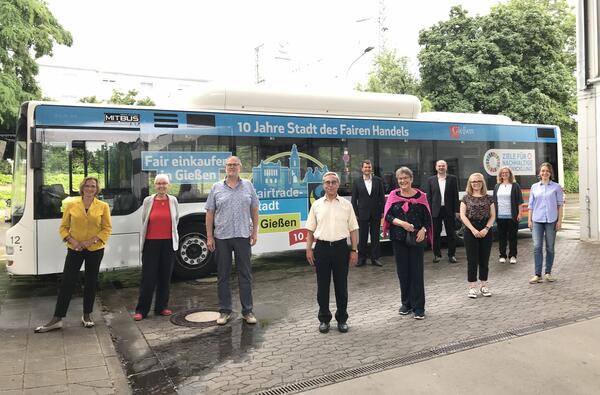 Oberbürgermeisterin Dietlind Grabe-Bolz und Mitglieder der Steuerungsgruppe Fairtrade-Stadt Gießen vor dem neugestalteten Bus, den der Geschäftsführer der MIT.BUS GmbH, Mathias Carl 6. von rechts) übergibt.