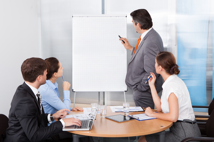 Businessman Giving Presentation To His Colleagues At Conference